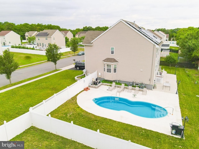 view of swimming pool featuring a patio and a lawn