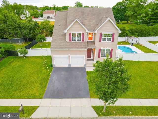 view of front of home featuring a garage and a front lawn