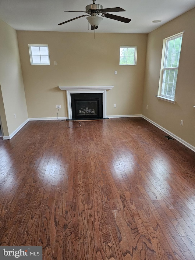 unfurnished living room with hardwood / wood-style floors and ceiling fan