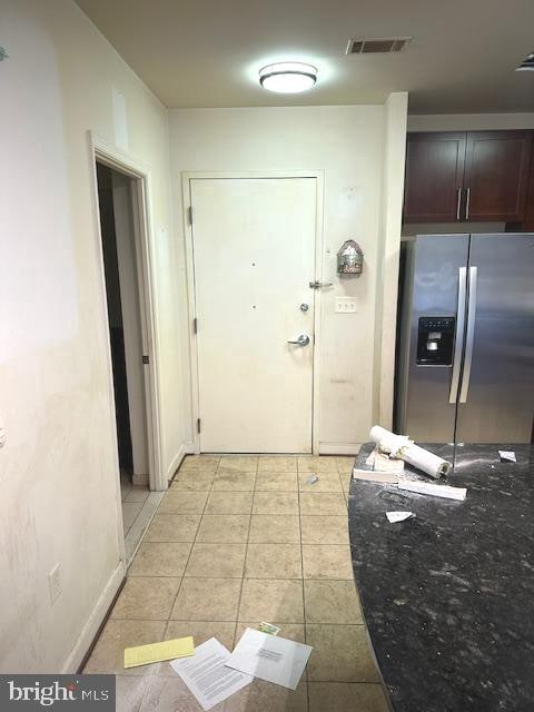 doorway with light tile floors