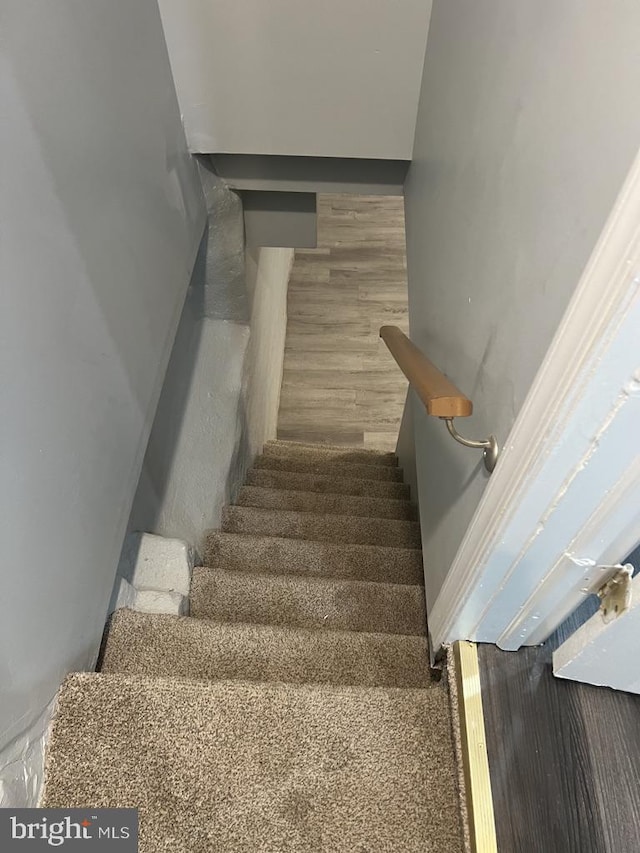 stairs with wood-type flooring