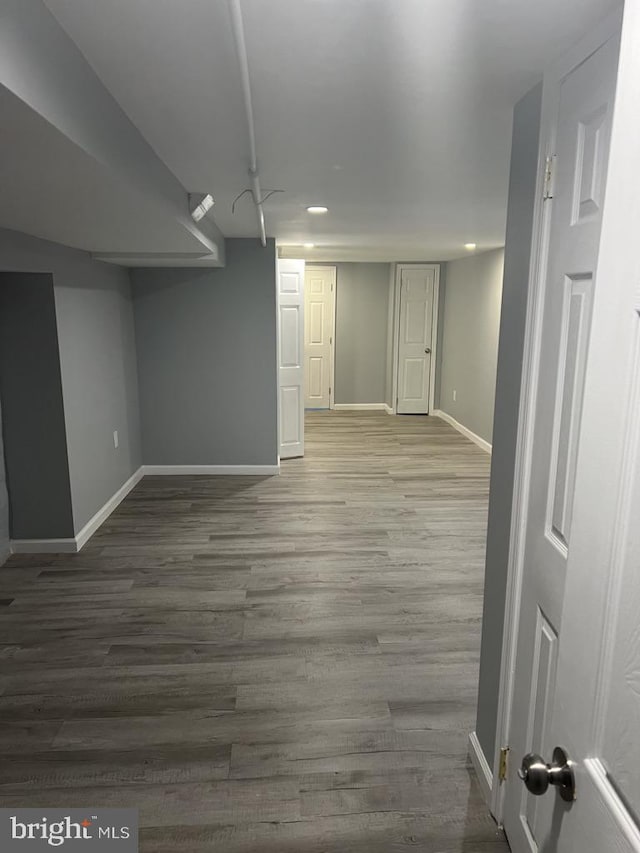 basement with hardwood / wood-style flooring