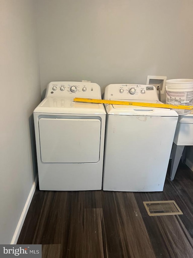 laundry area featuring washer and dryer, washer hookup, and wood-type flooring