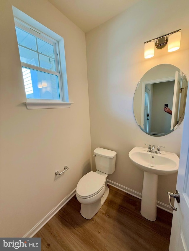 bathroom featuring sink, hardwood / wood-style floors, and toilet