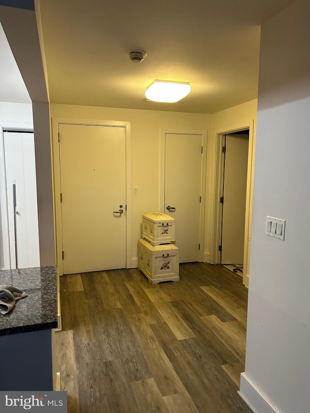 hall with dark hardwood / wood-style floors