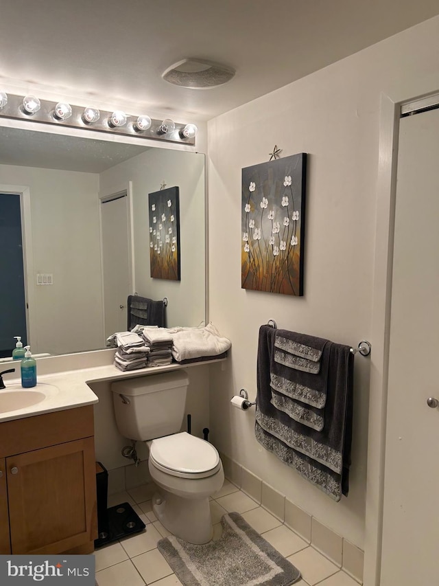 bathroom with tile patterned flooring, vanity, and toilet