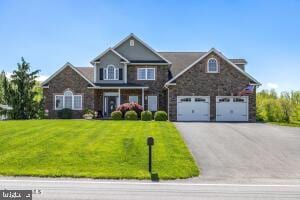 view of front of house featuring a garage and a front yard