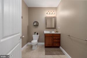 bathroom featuring tile floors, toilet, and large vanity