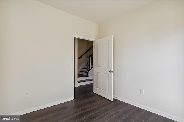 unfurnished room featuring dark hardwood / wood-style flooring