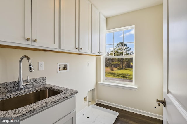 kitchen featuring white cabinetry, sink, dark wood-type flooring, and light stone counters