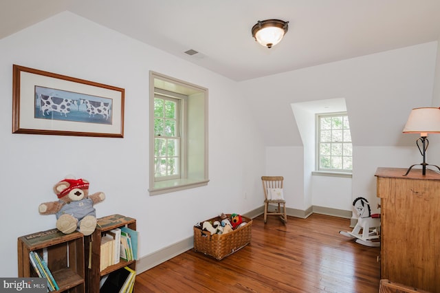 living area with vaulted ceiling and wood-type flooring