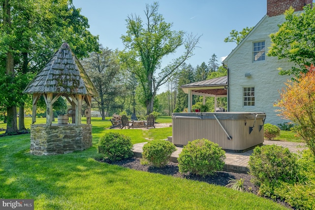 view of yard with a gazebo and a hot tub