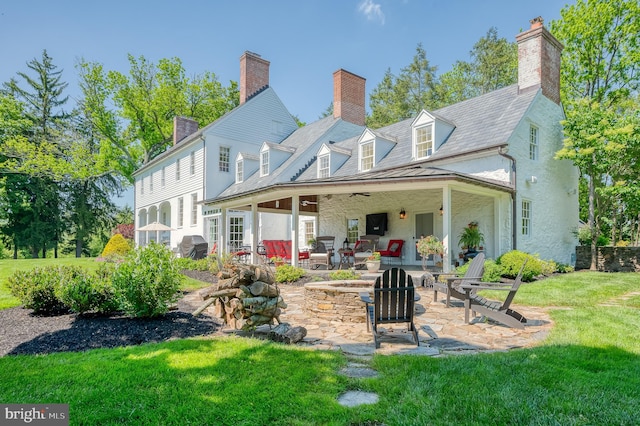 back of property featuring a patio and a yard