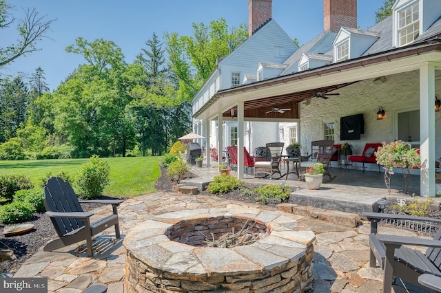 view of patio / terrace featuring an outdoor fire pit and ceiling fan