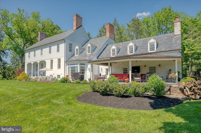 rear view of house featuring a lawn