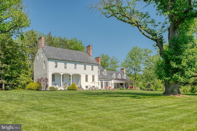 colonial-style house with a front yard