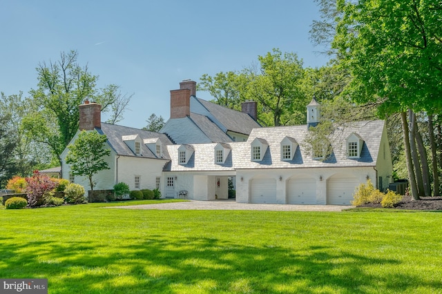 rear view of property featuring a garage, a yard, and central air condition unit