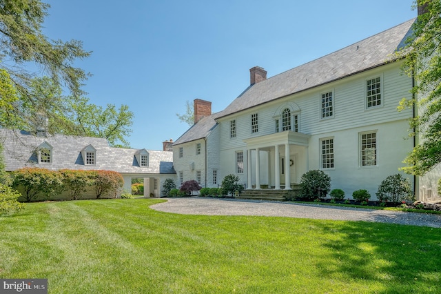 rear view of property with a yard