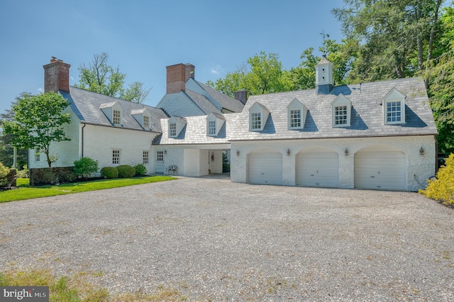 cape cod house featuring a garage