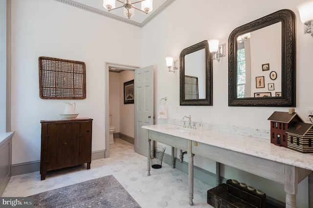 bathroom featuring ornamental molding, toilet, and vanity