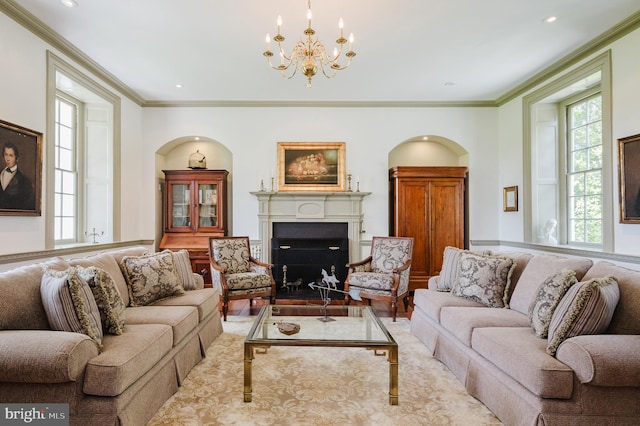 living room with an inviting chandelier, hardwood / wood-style floors, and crown molding