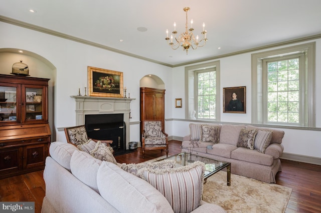 living room with ornamental molding, an inviting chandelier, and dark wood-type flooring