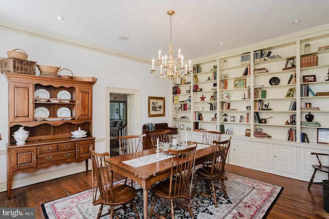 dining space featuring a notable chandelier, ornamental molding, dark hardwood / wood-style flooring, and built in shelves