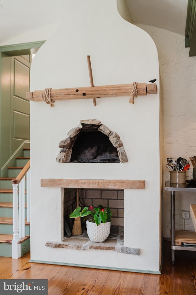 room details with a brick fireplace and hardwood / wood-style floors