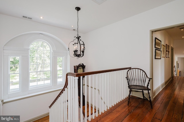 hallway featuring a notable chandelier and dark hardwood / wood-style flooring