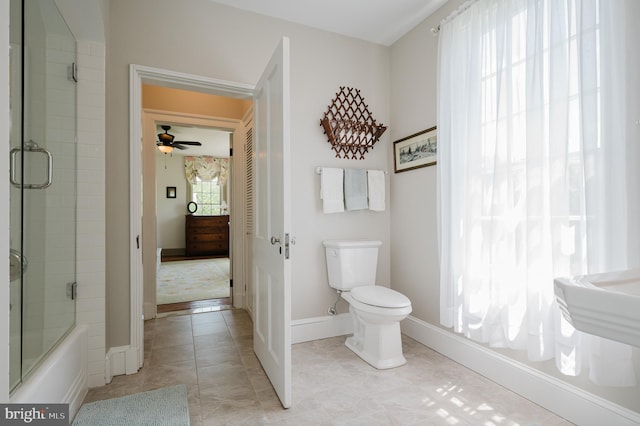 bathroom featuring ceiling fan, tile flooring, combined bath / shower with glass door, and toilet