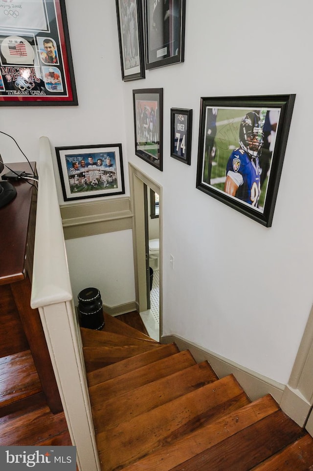 stairway featuring dark wood-type flooring