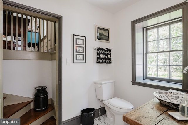 bathroom featuring tile flooring and toilet