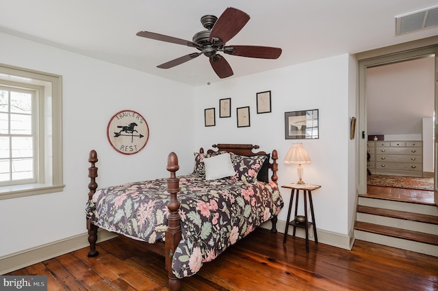 bedroom with dark hardwood / wood-style flooring and ceiling fan