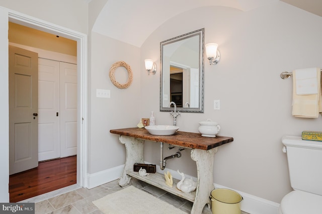 bathroom with tile flooring, sink, and toilet