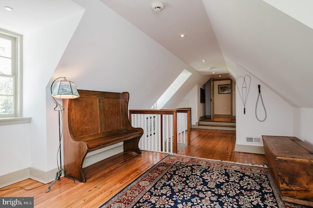 sitting room featuring hardwood / wood-style flooring and lofted ceiling