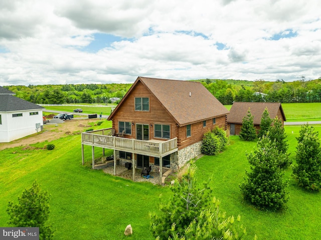 rear view of house with a lawn and a wooden deck