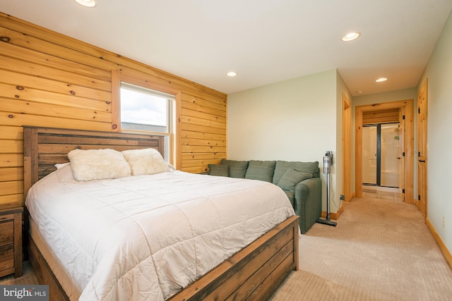 bedroom with light carpet, wood walls, and recessed lighting