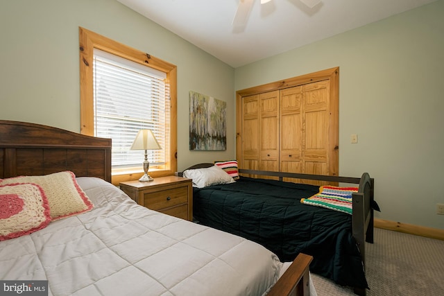 carpeted bedroom with a closet, a ceiling fan, and baseboards