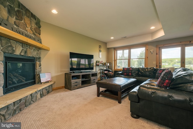 carpeted living area featuring recessed lighting, a fireplace, and baseboards