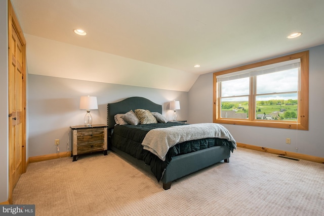 bedroom with recessed lighting, light carpet, vaulted ceiling, and baseboards