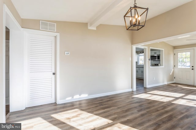 unfurnished dining area featuring beamed ceiling, hardwood / wood-style floors, and a chandelier