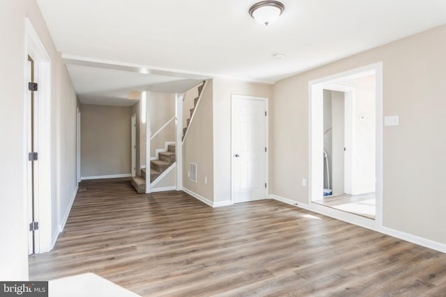 unfurnished living room featuring hardwood / wood-style flooring