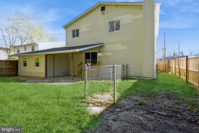 back of property featuring a lawn