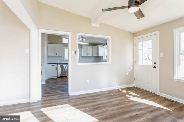 entrance foyer with ceiling fan, lofted ceiling with beams, and wood-type flooring