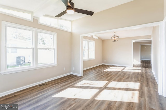 spare room with wood-type flooring, beam ceiling, and ceiling fan