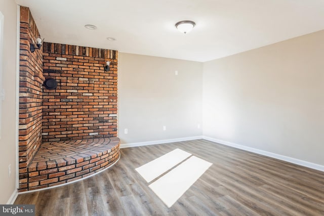 spare room featuring wood-type flooring