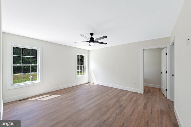 empty room featuring ceiling fan and light hardwood / wood-style floors