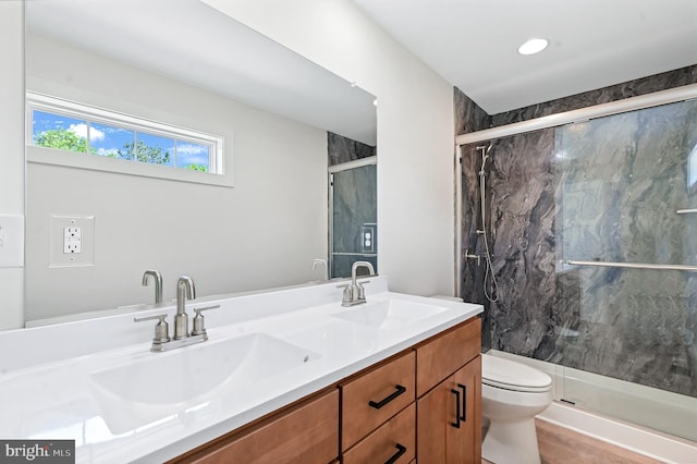 bathroom with vanity, hardwood / wood-style flooring, toilet, and walk in shower