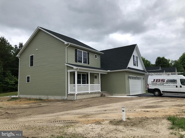 view of front of house with covered porch and a garage