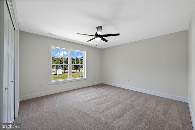 carpeted empty room with ceiling fan